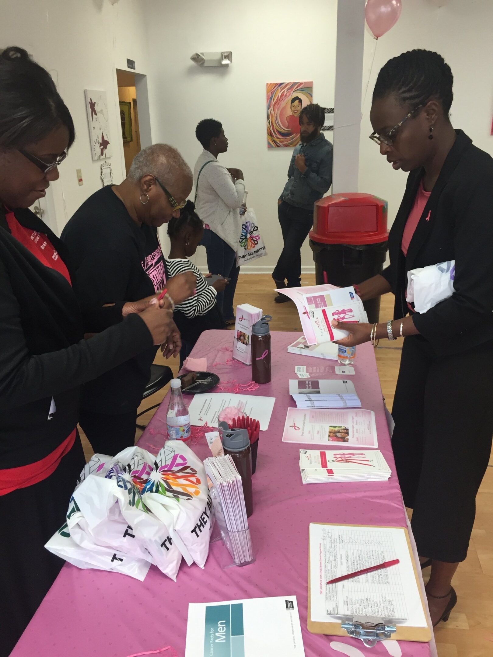 People interacting at information table